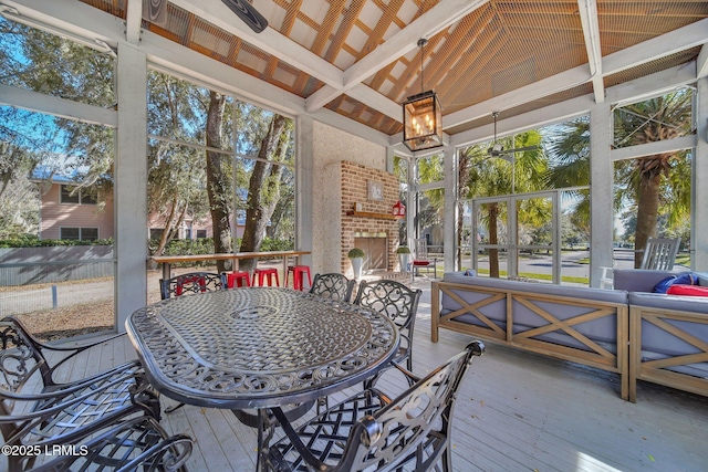 sunroom / solarium featuring vaulted ceiling and a healthy amount of sunlight