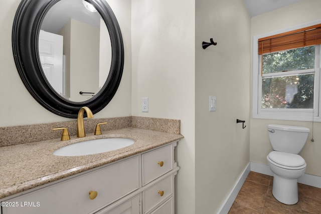 bathroom with vanity, tile patterned floors, and toilet