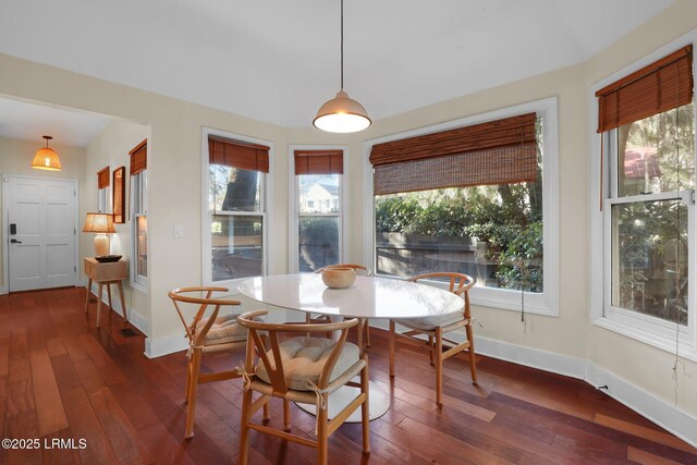 dining space with dark wood-type flooring