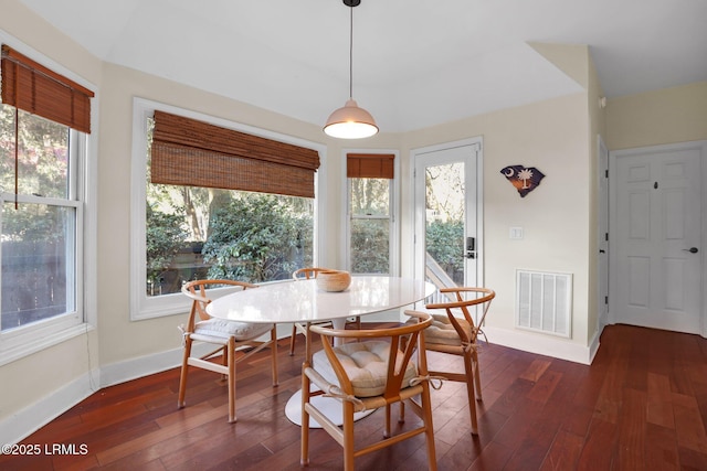 dining room with a healthy amount of sunlight and dark hardwood / wood-style floors