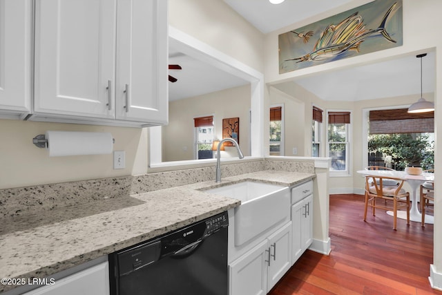 kitchen with white cabinets, light stone countertops, and dishwasher