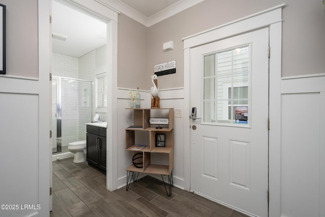 123 Sandcastle Ct, Hilton Head Island, SC 29928 - entryway with crown molding, wood finish floors, and a wainscoted wall