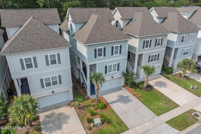123 Sandcastle Ct, Hilton Head Island, SC 29928 - beach home with a shingled roof, an attached garage, board and batten siding, and driveway