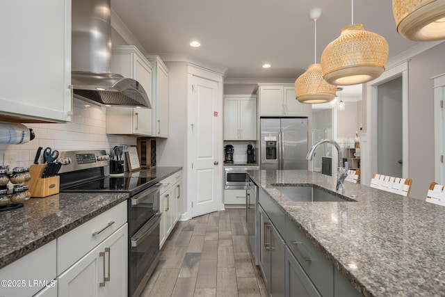 123 Sandcastle Ct, Hilton Head Island, SC 29928 - kitchen with wall chimney range hood, stainless steel appliances, a sink, wood finished floors, and backsplash