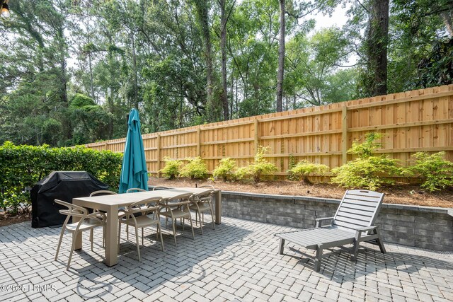 123 Sandcastle Ct, Hilton Head Island, SC 29928 - view of patio featuring outdoor dining area and a grill