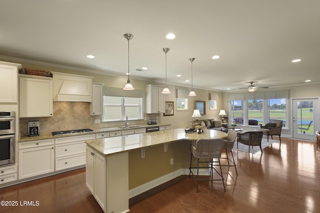509 Nautical Ln, Okatie, SC 29909 - kitchen with a sink, stainless steel appliances, a center island, open floor plan, and light stone countertops