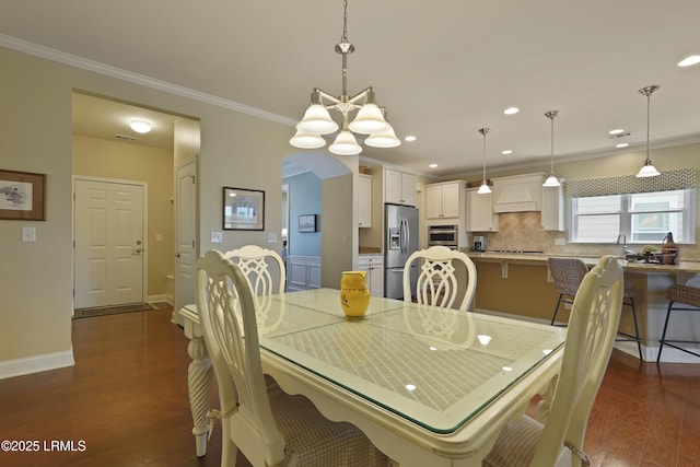 509 Nautical Ln, Okatie, SC 29909 - dining area with arched walkways, ornamental molding, dark wood-type flooring, recessed lighting, and baseboards