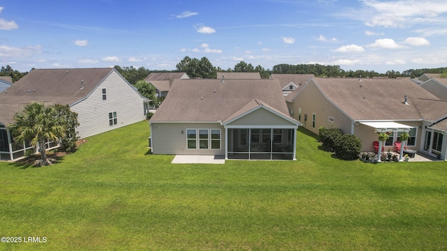 509 Nautical Ln, Okatie, SC 29909 - rear view of house with a sunroom, a patio area, a lawn, and a shingled roof