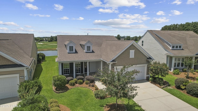 509 Nautical Ln, Okatie, SC 29909 - cape cod-style house featuring driveway, a garage, a front lawn, a water view, and a porch