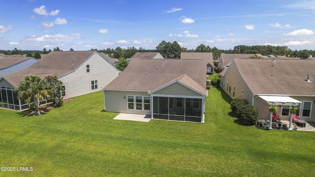 509 Nautical Ln, Okatie, SC 29909 - rear view of property featuring a sunroom, a yard, roof with shingles, and a patio