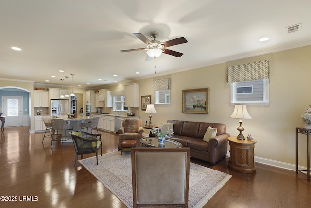 509 Nautical Ln, Okatie, SC 29909 - living room with ceiling fan, ornamental molding, baseboards, arched walkways, and dark wood finished floors