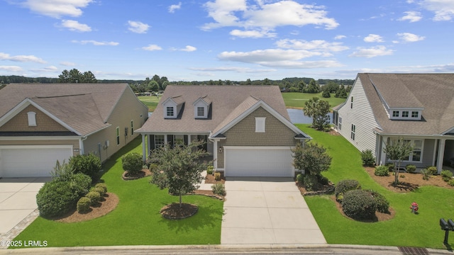 509 Nautical Ln, Okatie, SC 29909 - view of front of home with concrete driveway, an attached garage, and a front yard