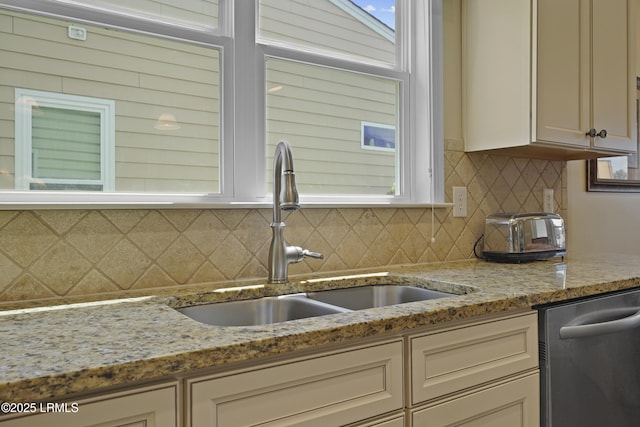 509 Nautical Ln, Okatie, SC 29909 - kitchen with dishwasher, a sink, tasteful backsplash, and light stone countertops