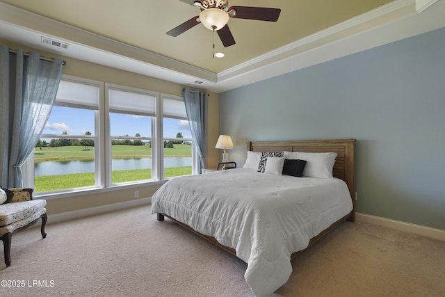 509 Nautical Ln, Okatie, SC 29909 - carpeted bedroom featuring a raised ceiling, baseboards, ornamental molding, a water view, and a ceiling fan