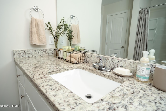 bathroom featuring walk in shower and vanity