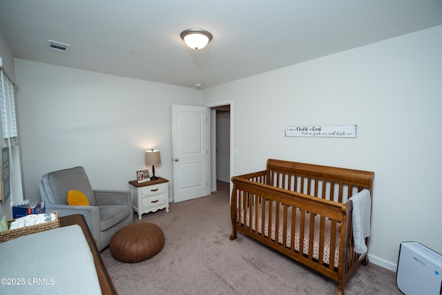 carpeted bedroom featuring a crib