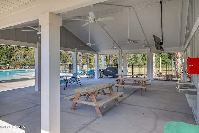 view of patio with ceiling fan, area for grilling, and a fenced in pool