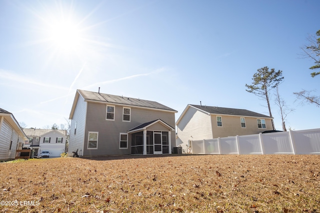 rear view of property with a sunroom