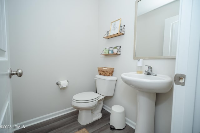 bathroom with hardwood / wood-style floors, sink, and toilet