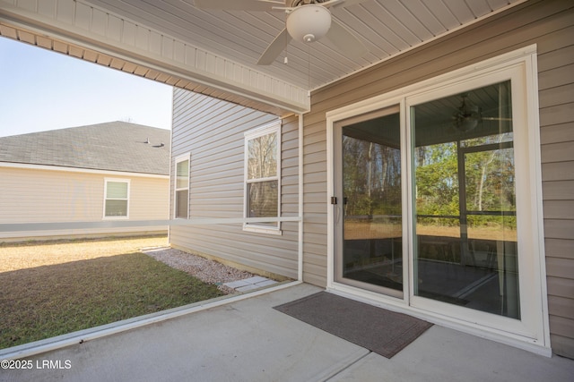 view of exterior entry featuring a patio area and ceiling fan