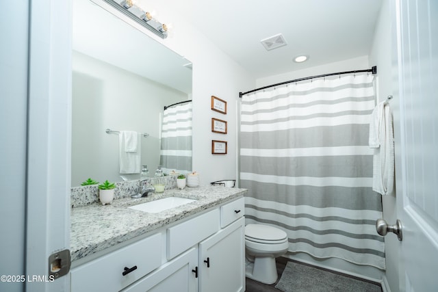 bathroom featuring vanity, toilet, and a shower with shower curtain