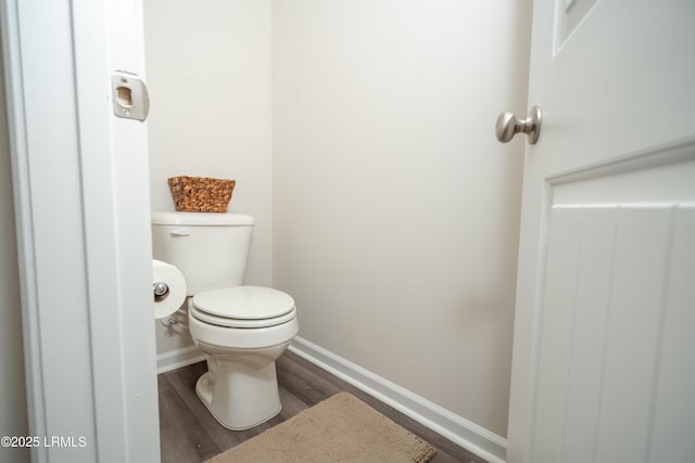 bathroom featuring hardwood / wood-style flooring and toilet