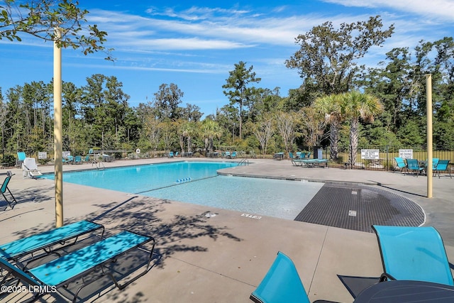 view of swimming pool with a patio area