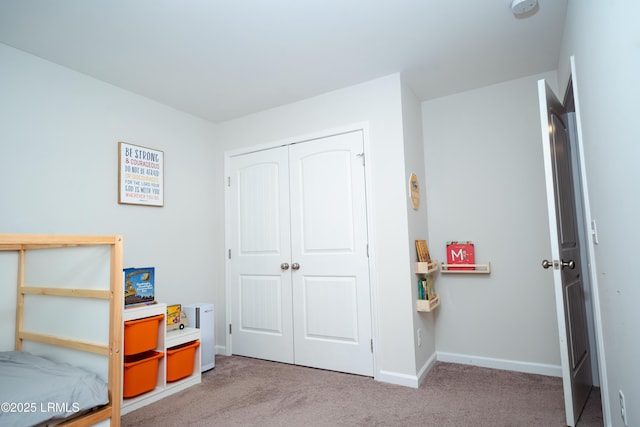 bedroom with light colored carpet and a closet