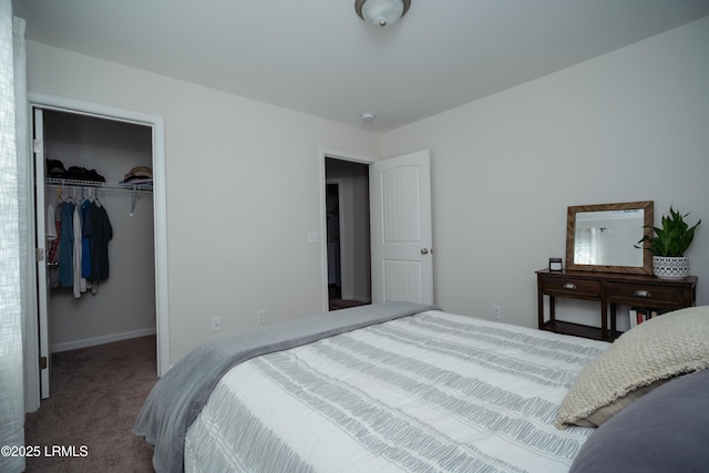 carpeted bedroom featuring a walk in closet and a closet