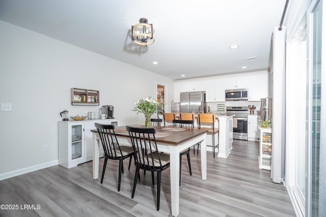 dining space featuring a chandelier and light hardwood / wood-style floors