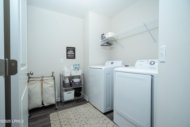 laundry area with light hardwood / wood-style flooring and washer and clothes dryer