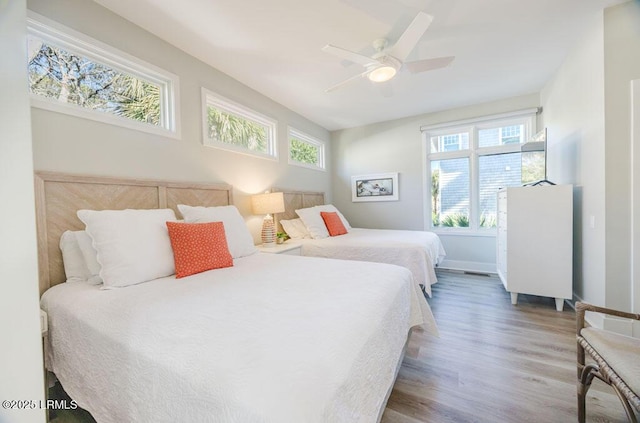 bedroom with hardwood / wood-style flooring and ceiling fan