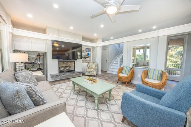 living room featuring ceiling fan and light hardwood / wood-style floors