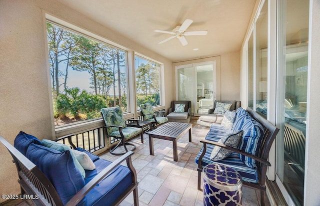 sunroom featuring ceiling fan