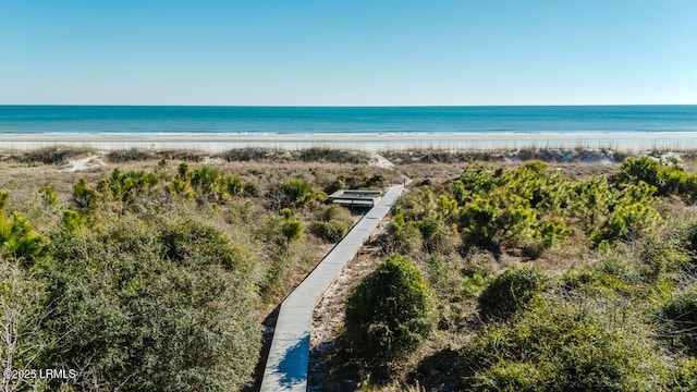 bird's eye view with a water view and a beach view