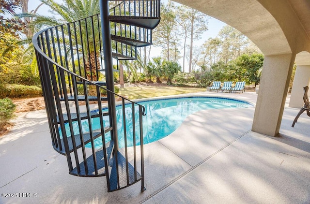 view of swimming pool featuring a patio area