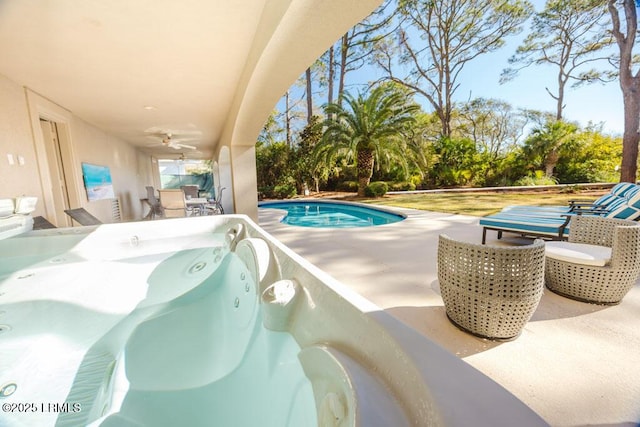 view of pool with a patio area and ceiling fan