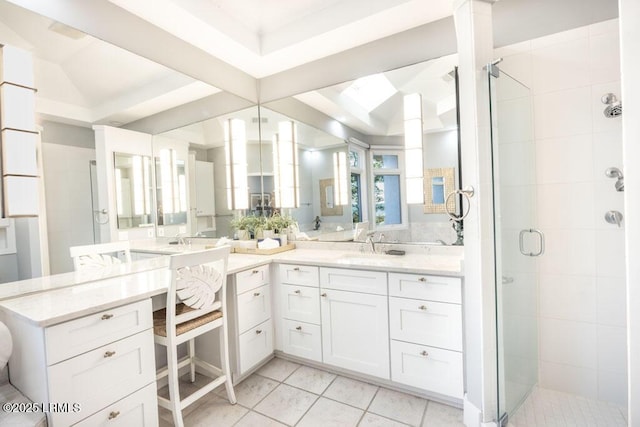 bathroom featuring vanity, vaulted ceiling, tile patterned floors, and walk in shower