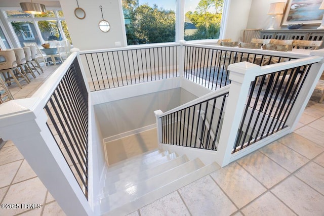 staircase featuring plenty of natural light