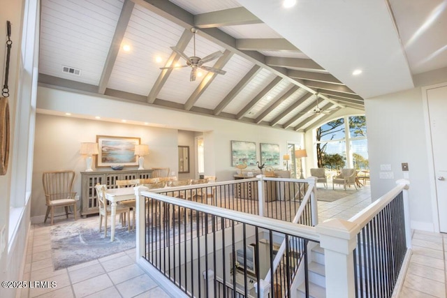 hall with high vaulted ceiling, beamed ceiling, and light tile patterned flooring