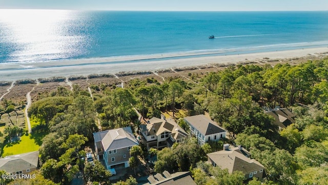 bird's eye view featuring a water view and a beach view