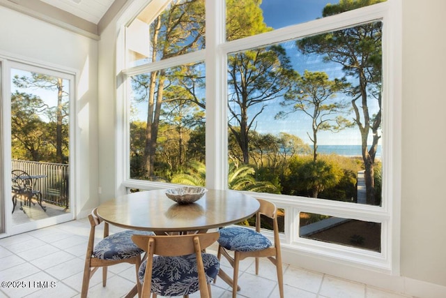 sunroom / solarium featuring a water view