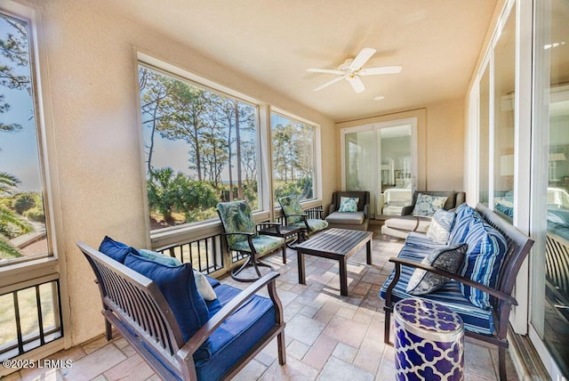 sunroom / solarium featuring ceiling fan