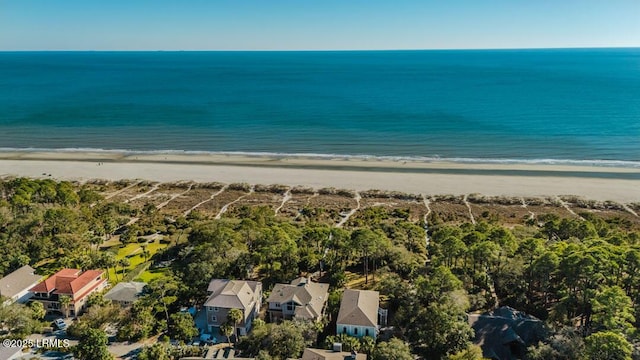 bird's eye view featuring a water view and a beach view