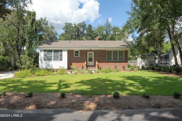 ranch-style home with a front lawn