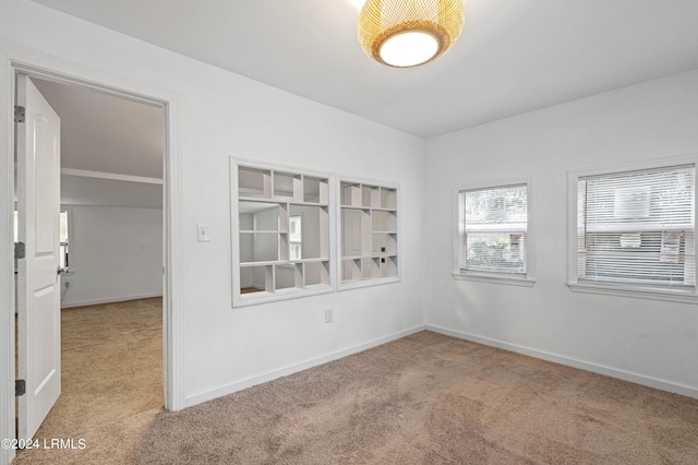 unfurnished room featuring light carpet