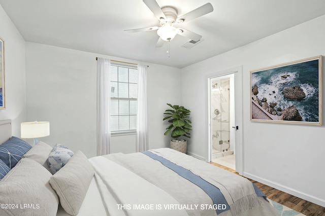 bedroom with ceiling fan, hardwood / wood-style floors, and ensuite bath