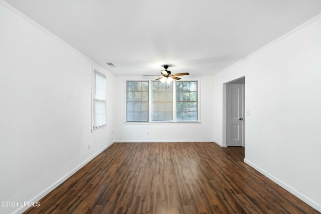 spare room with dark hardwood / wood-style flooring, crown molding, and ceiling fan