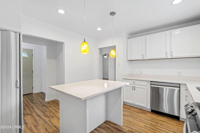 kitchen featuring decorative light fixtures, white cabinetry, a center island, stainless steel dishwasher, and light hardwood / wood-style floors