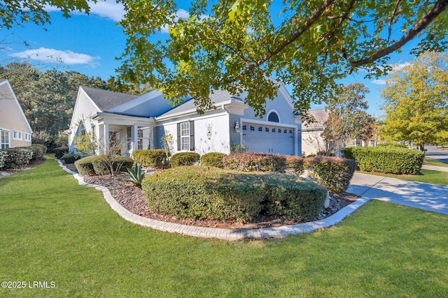26 Orion Pl, Okatie, SC 29909 - view of front facade with a garage, a front yard, stucco siding, and concrete driveway